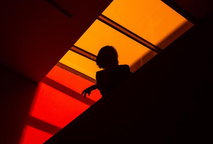 The silhouette of a woman in an architectural setting