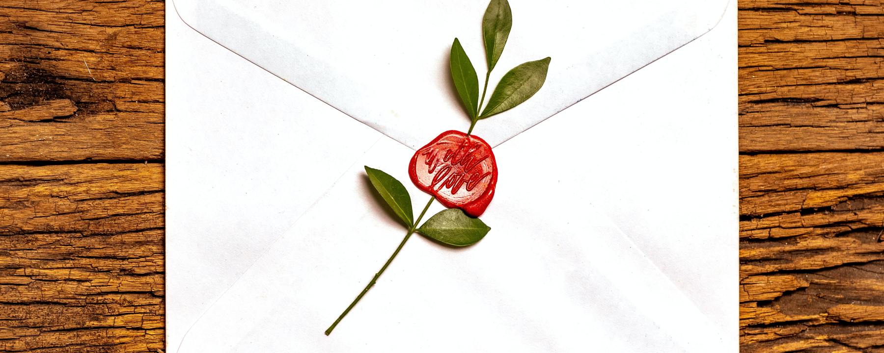 a letter sealed with wax imprinted "with love"