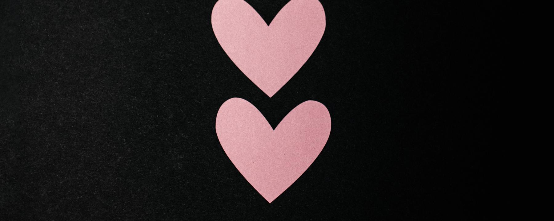 two paper hearts one beneath the other