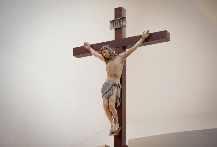 Jesus suffering on the cross. A crucifix with a white background