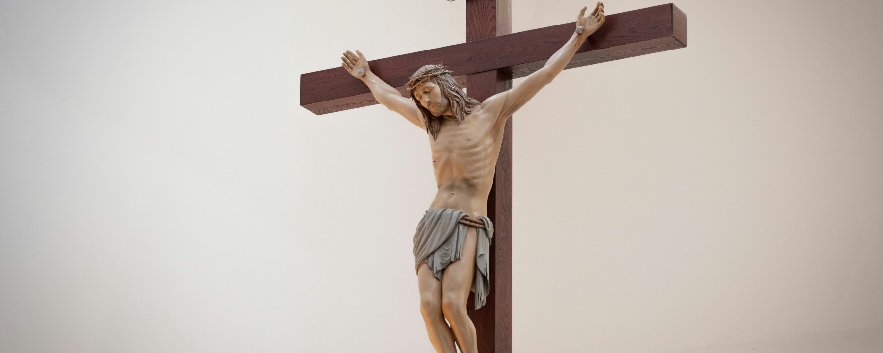 Jesus suffering on the cross. A crucifix with a white background