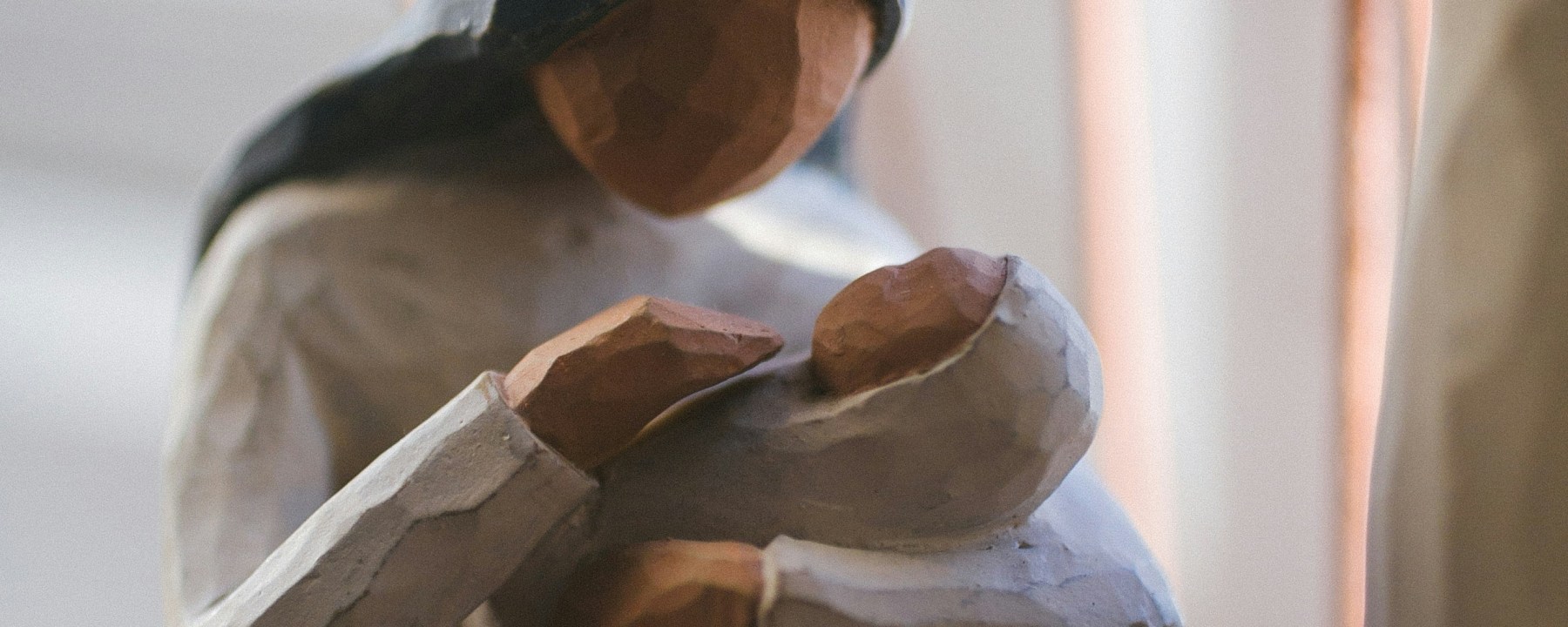 Willow tree woman cradling a baby