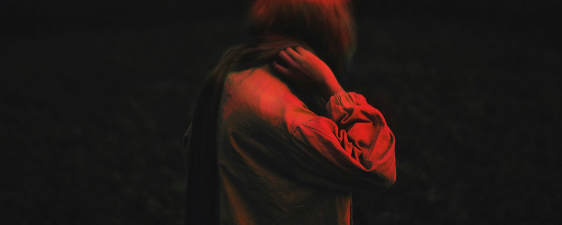 A human scratching neck with what looks like a halo above