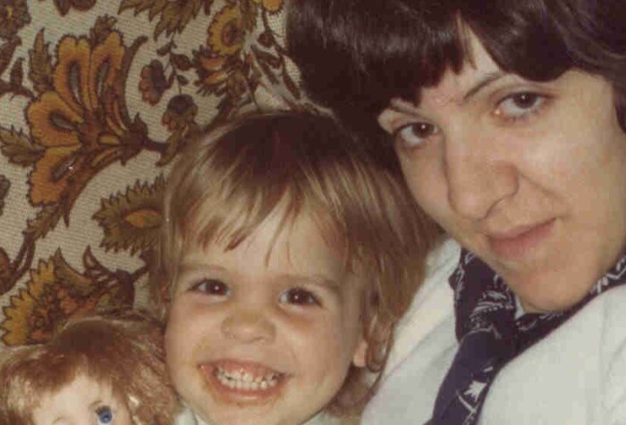 A mother holding a smiling child