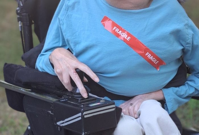 A woman in a wheelchair with fragile written across her chest