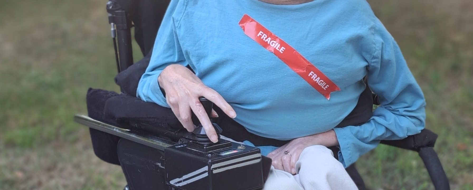 A woman in a wheelchair with fragile written across her chest
