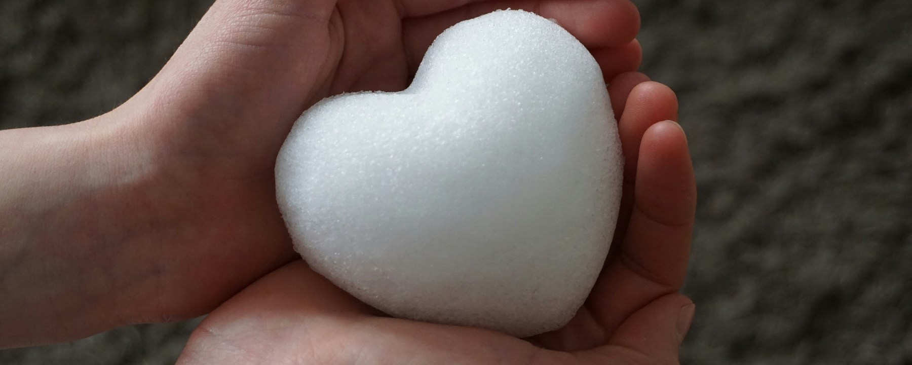 A heart held in two hands