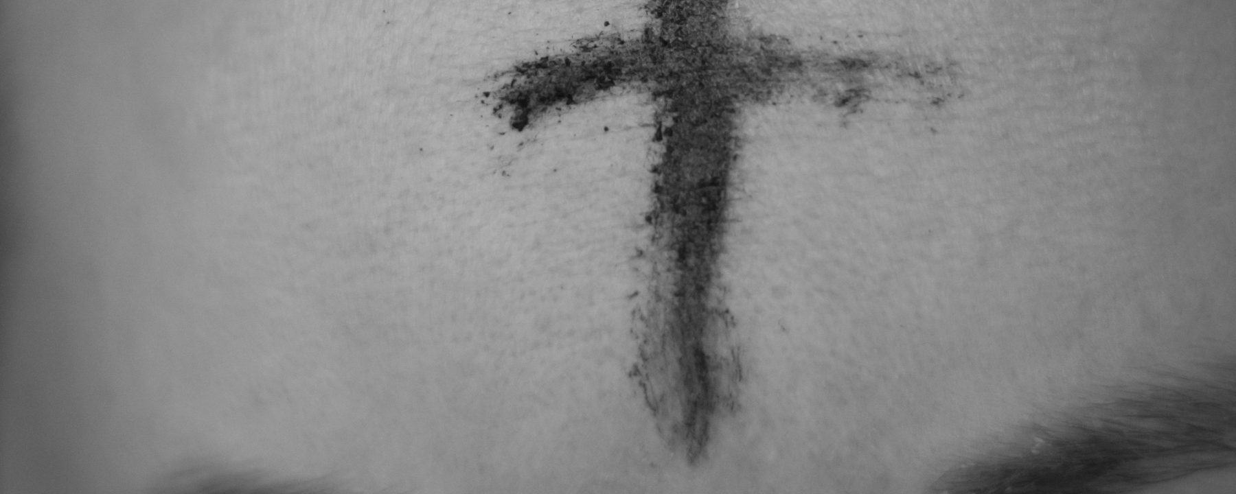 Image of a cross in ashes on a forehead